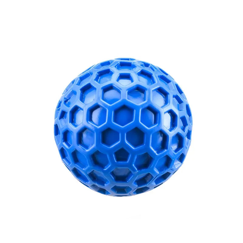 A tough arctic sky blue natural rubber squeaky dog ball displaying its bite-resistant hexagonal honeycomb design built for aggressive chewers' dental health.