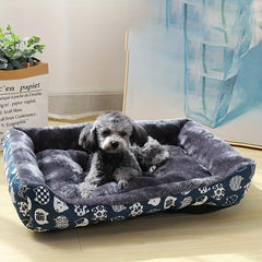 A blue patterned plush pet sofa bed with a dark grey interior for dogs and cats.