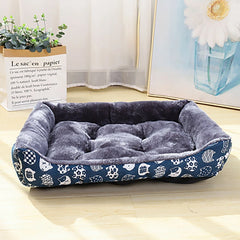 A blue patterned plush pet sofa bed with a dark grey interior for dogs and cats.