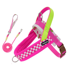 A bright hot pink step-in puppy harness and matching pink leash with an adjustable neon green strap and pink and white checker patterns.