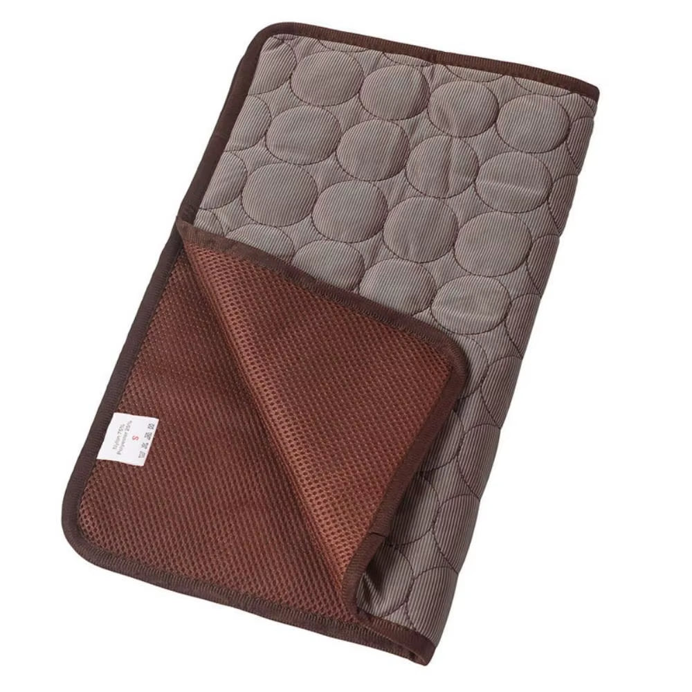 An espresso coffee colored washable summer dog cooling pad spread out on a living room sofa to protect pets from overheating.